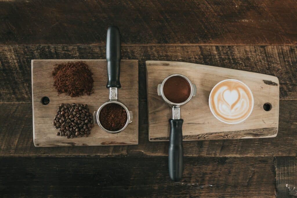 coffee beans beside coffee powder on brown wooden board - What is Coffee?